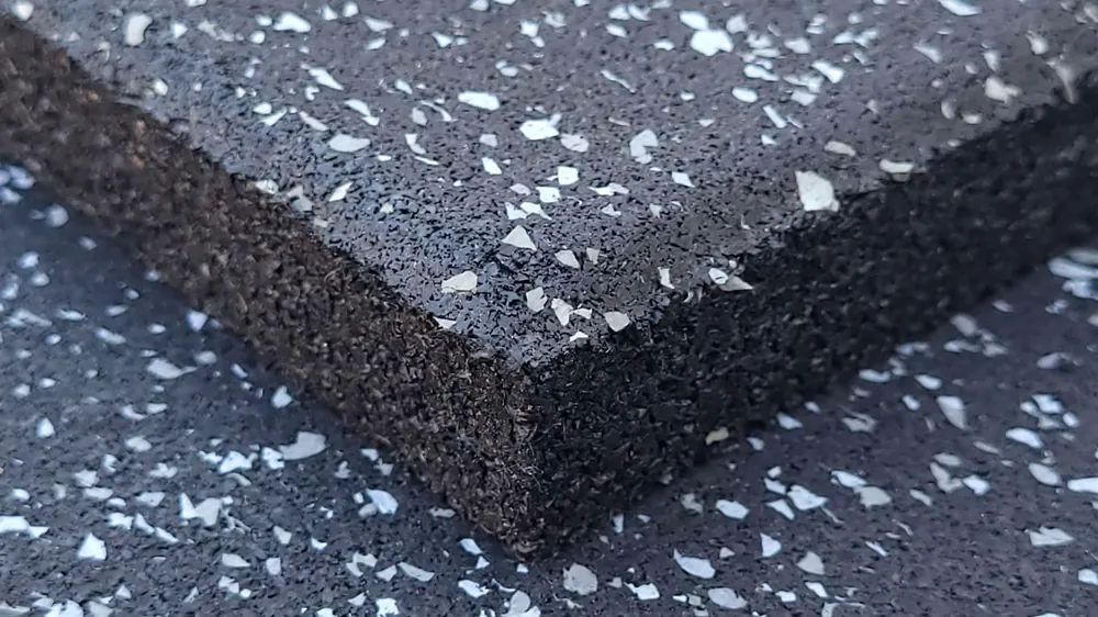 Detalle del borde de una placa ECO-GYM LAMINATED que muestra la estructura de dos capas